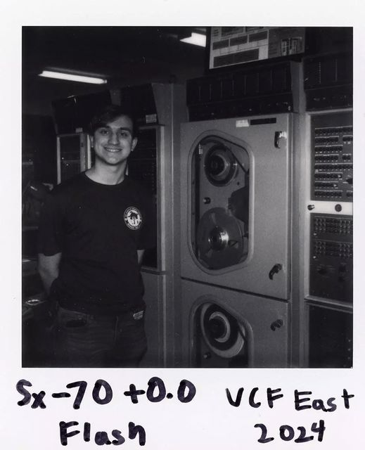 Steven Schiavone standing in front of the UNIVAC 1219B mainframe at VCF East 2024, photographed on Polaroid SX-70 film